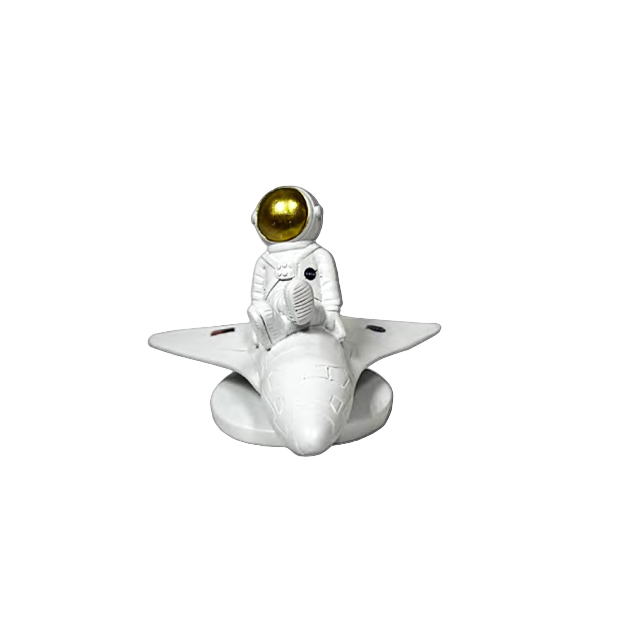 Small figurine of an astronaut on a rocket with a gold helmet against a transparent background